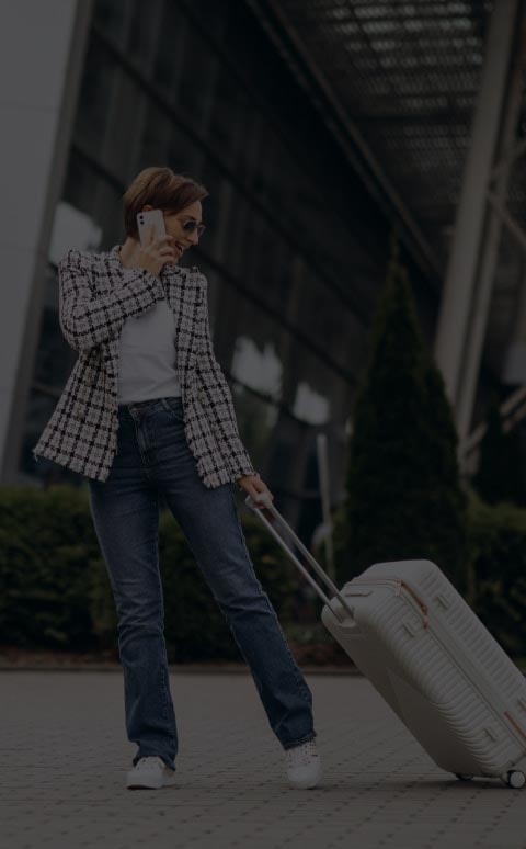 young-woman-with-luggage-airport-travelling-talking-phone